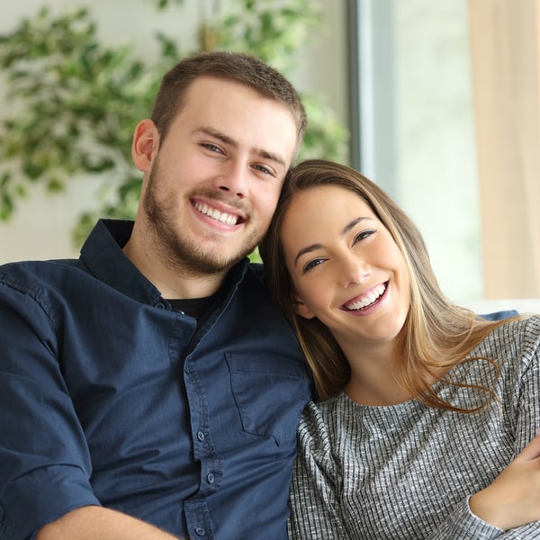 Happy smiling couple sitting on the couch