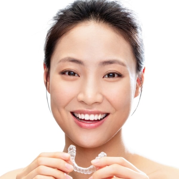 A girl with an Invisalign in her hands