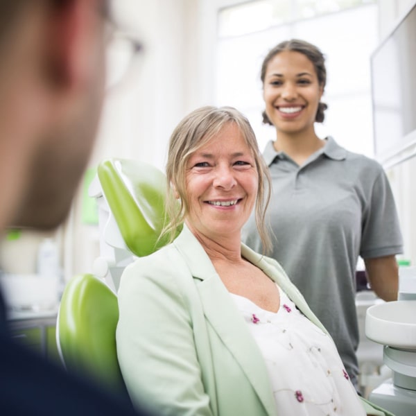 A happy patient is talking to a doctor
