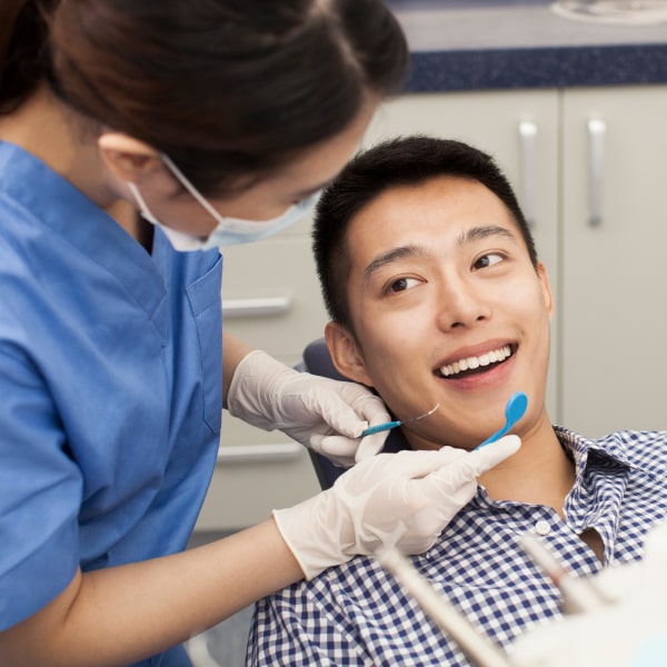 A smiling patient is preparing for the procedure
