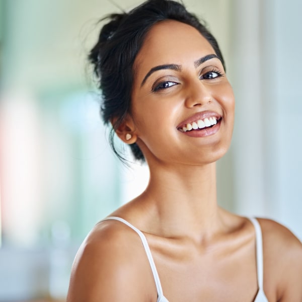 A woman with black hair is smiling