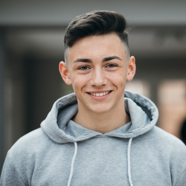 Smiling young guy looks happy